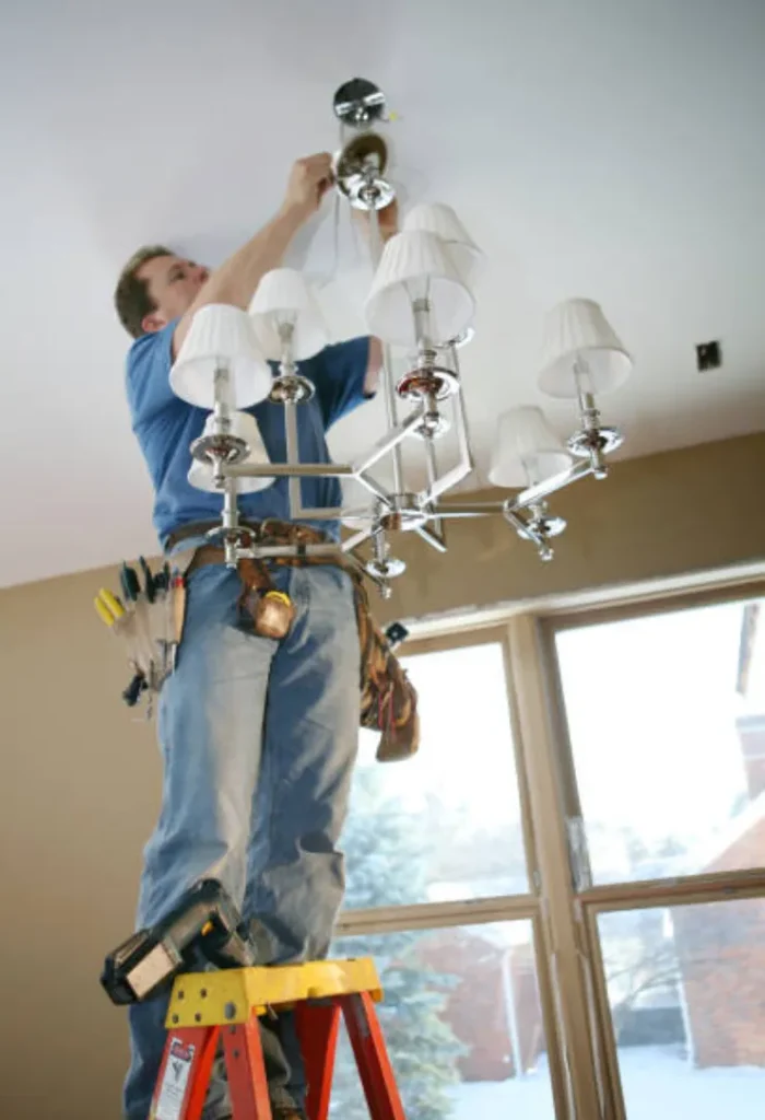Expert installing ceiling and light fixtures indoors