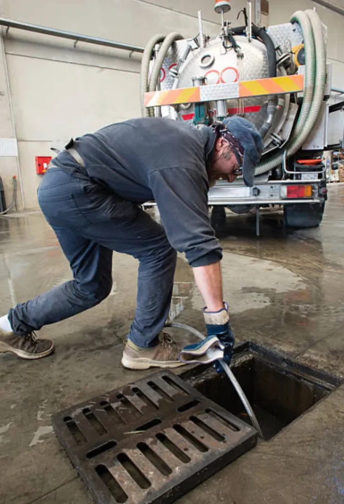Commercial grease trap and interceptor system undergoing routine maintenance